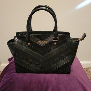 Michael Kors black handbag with multiple textures.
